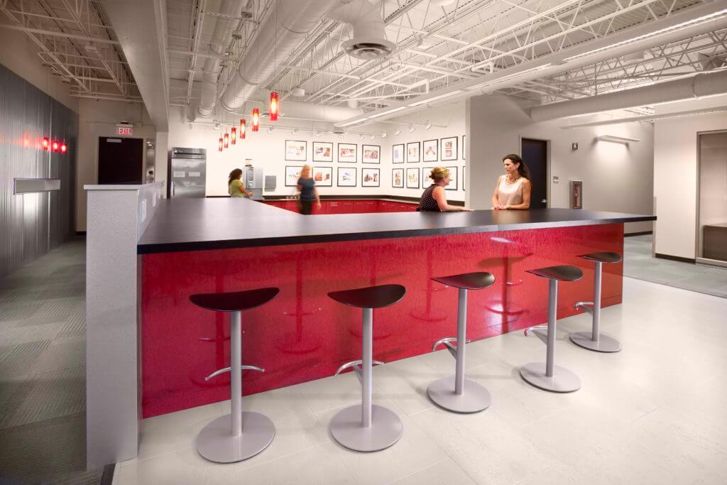 Employees gathering at coffee bar in office space