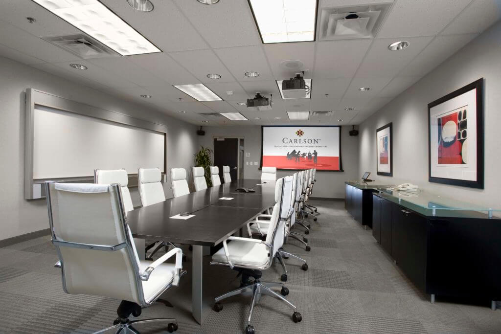 Conference room with long table and modern white chairs
